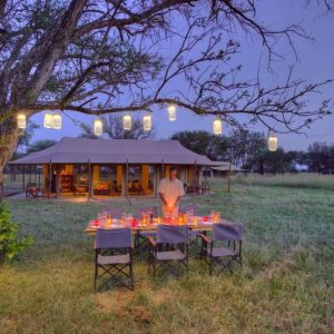 Kimondo camp outdoor dining experience under trees