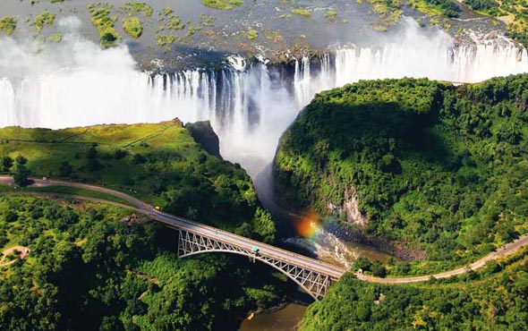 aerial view of a waterfall, a river and a railway bridge crossing a gorge