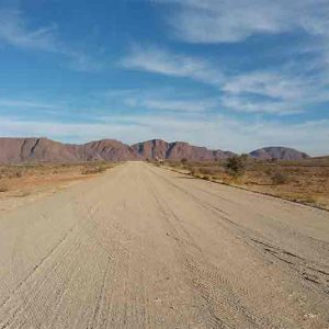 a dust road leading to the horizon in namibia