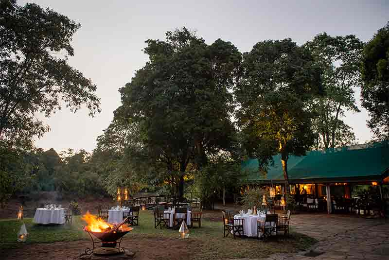 A fire burning with tables around it at early evening