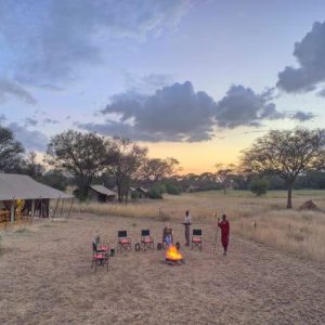 Ubuntu Camp guests enjoying sunset drinks on the open plains